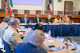 Secretary Jane Nelson sitting at a table facing other members of the committee